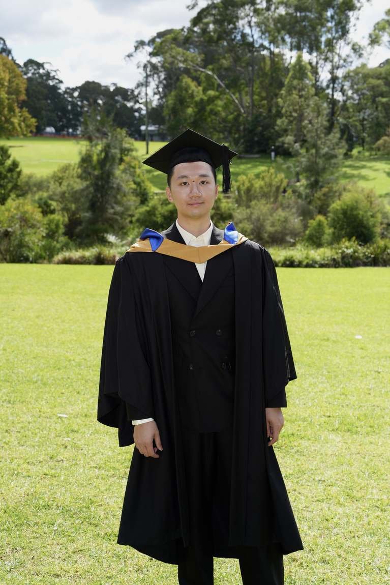 John Nguyen in graduation gown at Macquarie University